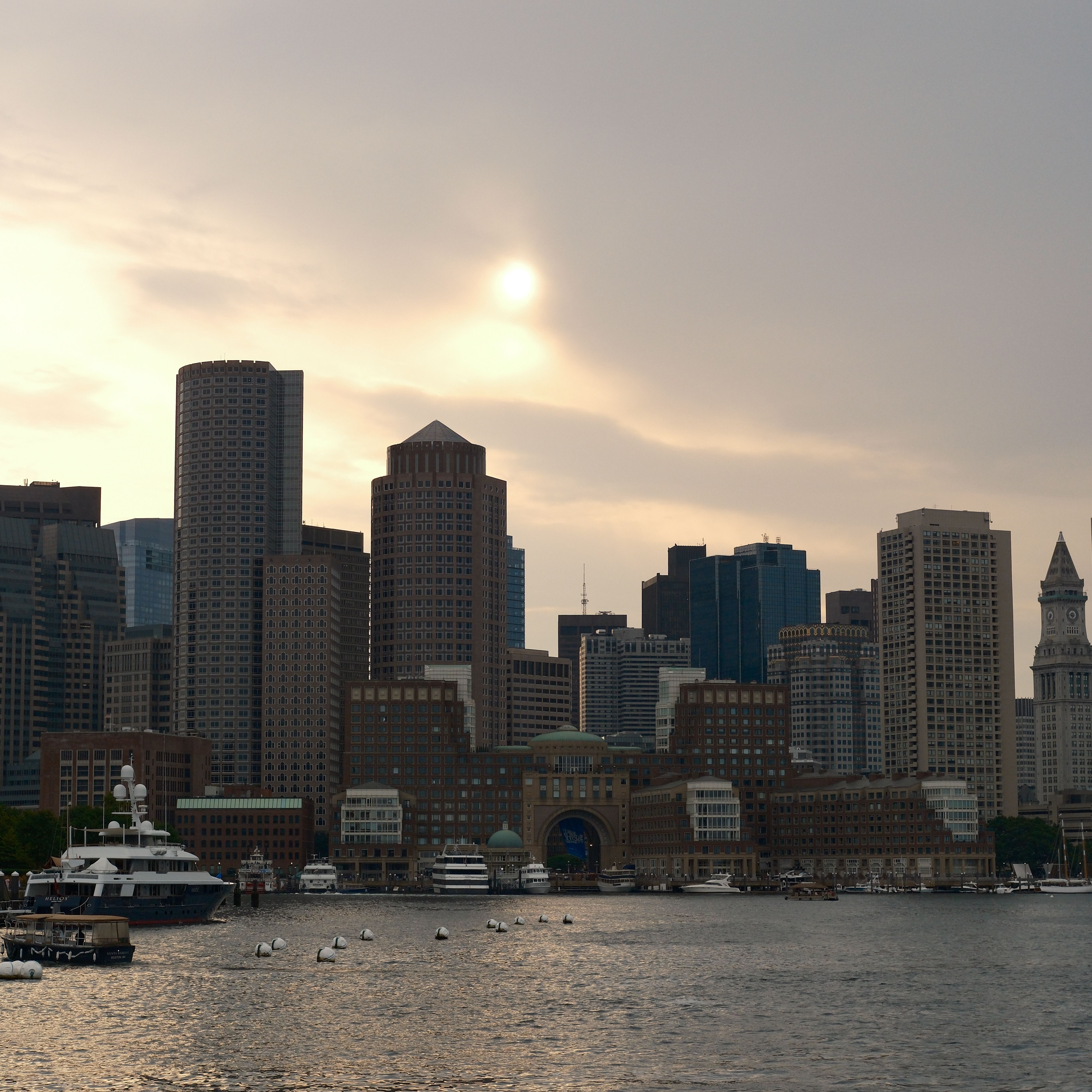 Boston skyline and harbor at dusk with a calming atmosphere