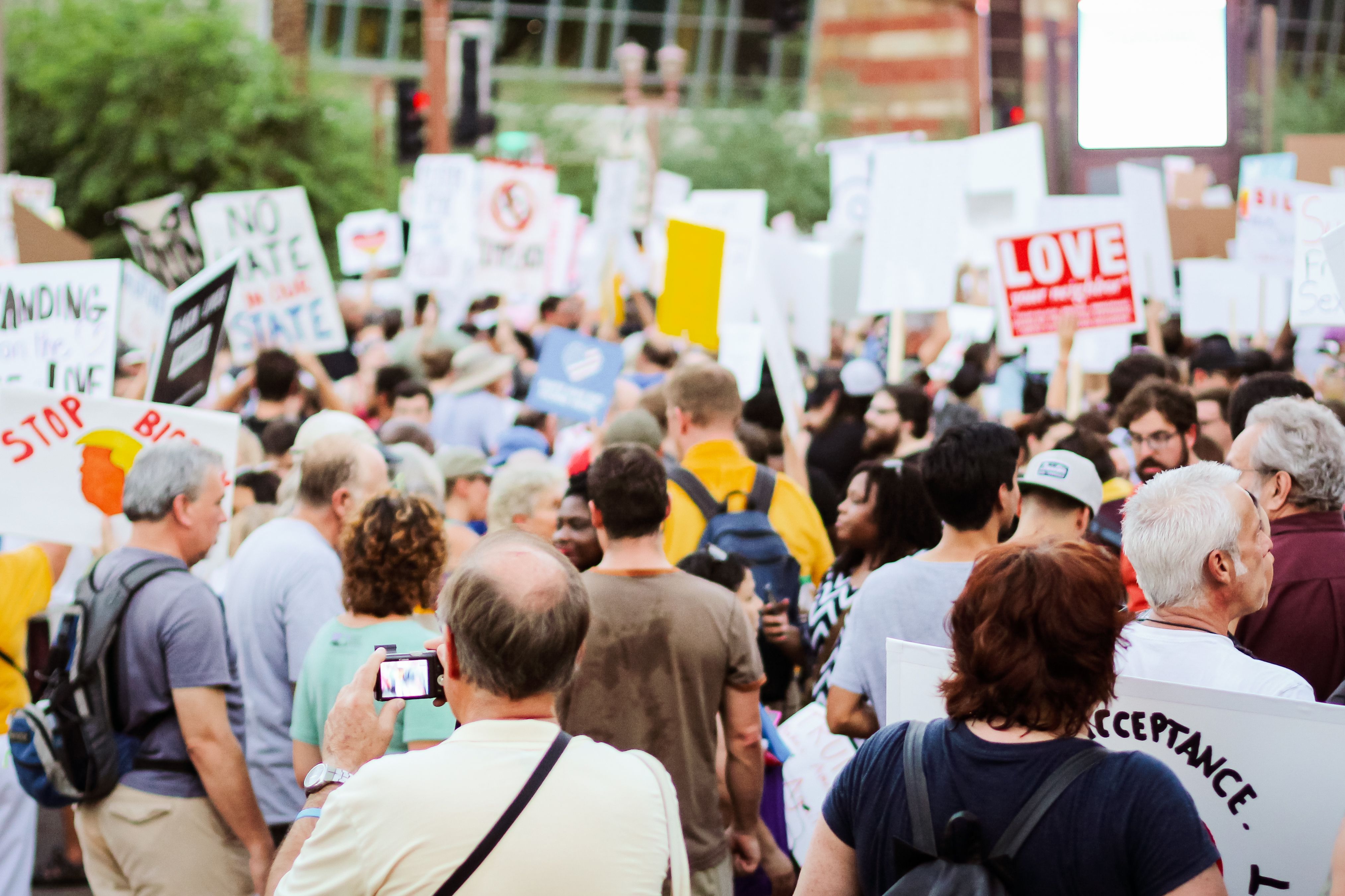 Back view of a crowd carrying banners at a group claim protest for justice