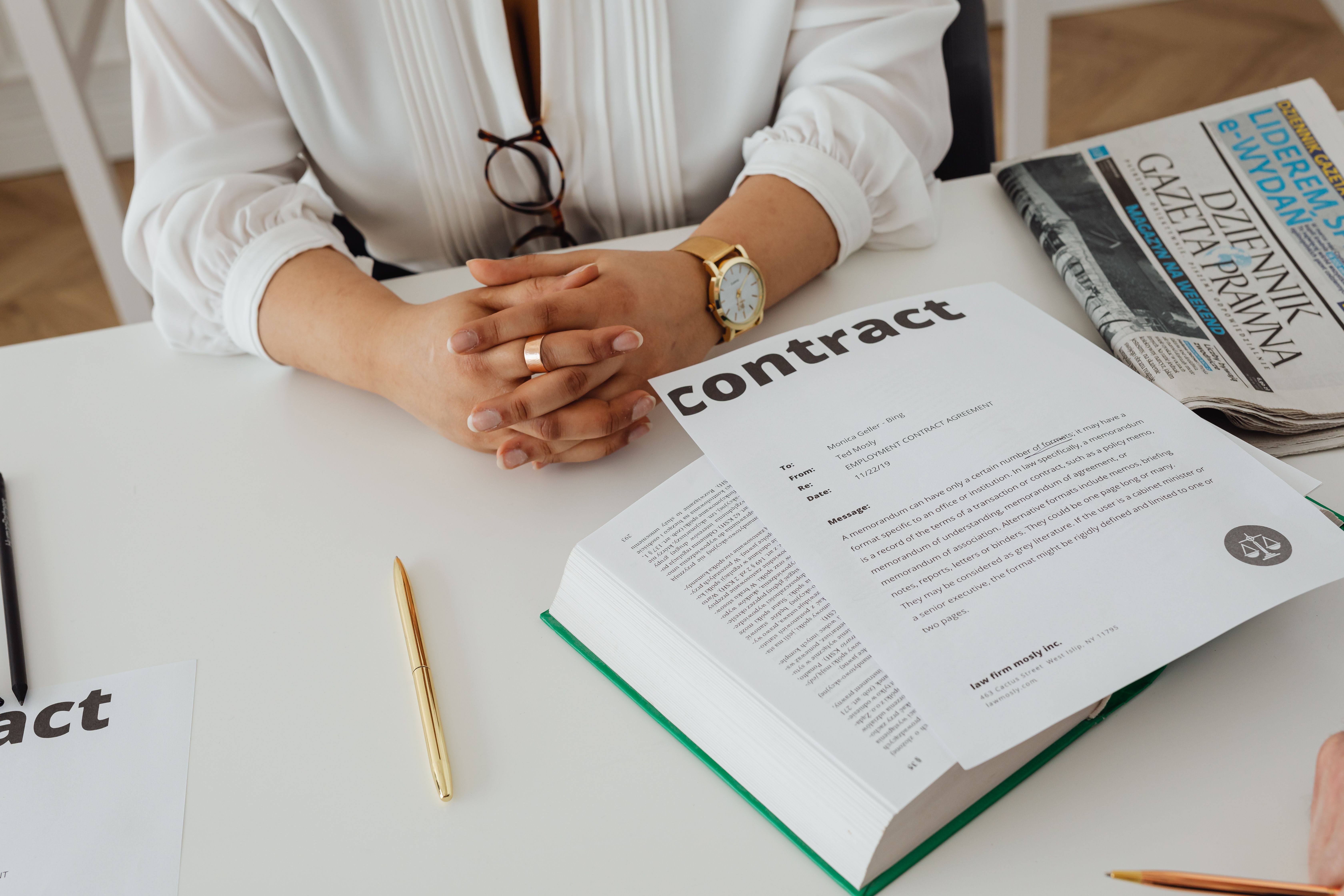 Businesswoman reviewing a contract and legal paperwork at a desk