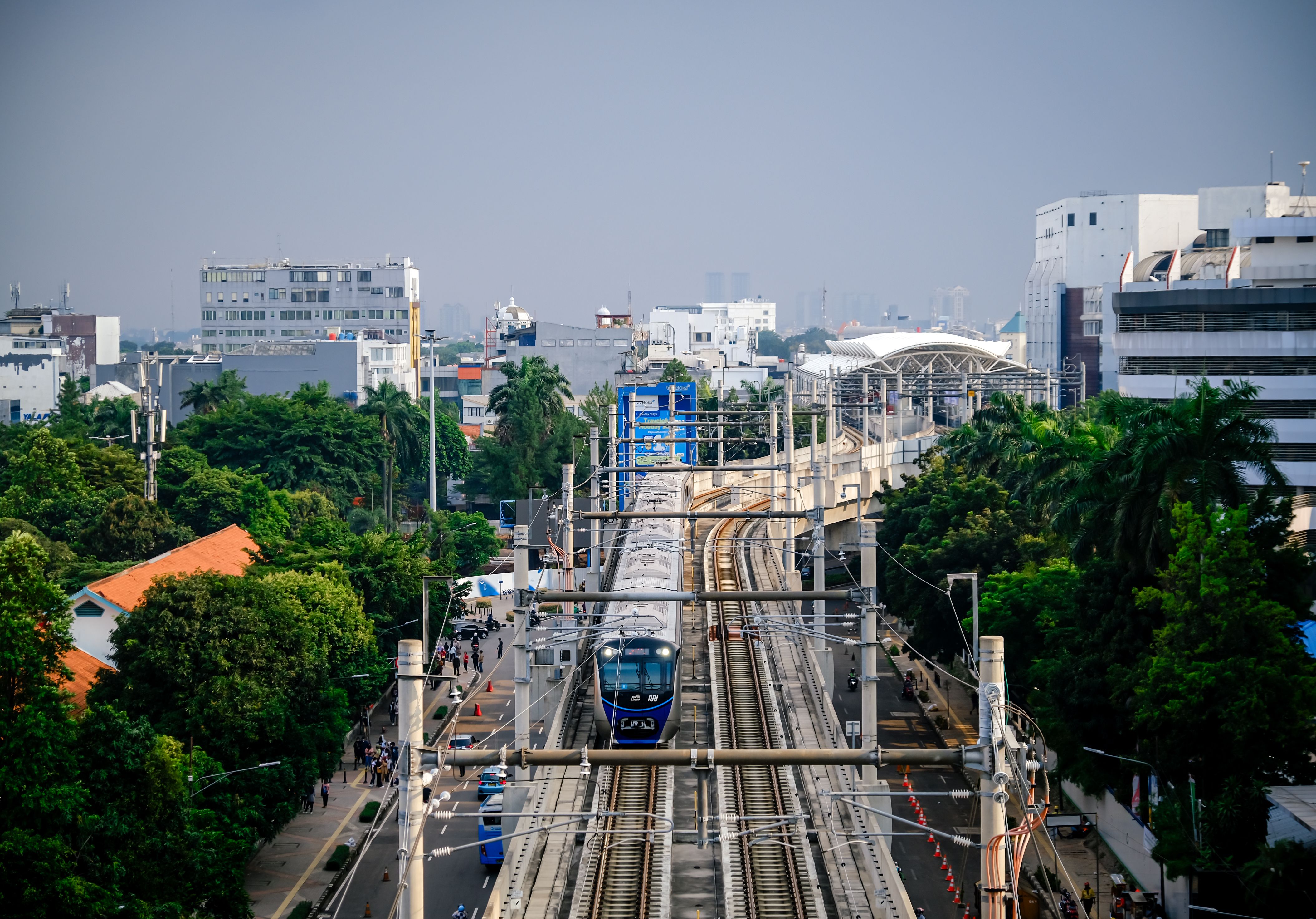 Modern MRT train on an elevated railway in Jakarta, representing urban mobility and infrastructure.