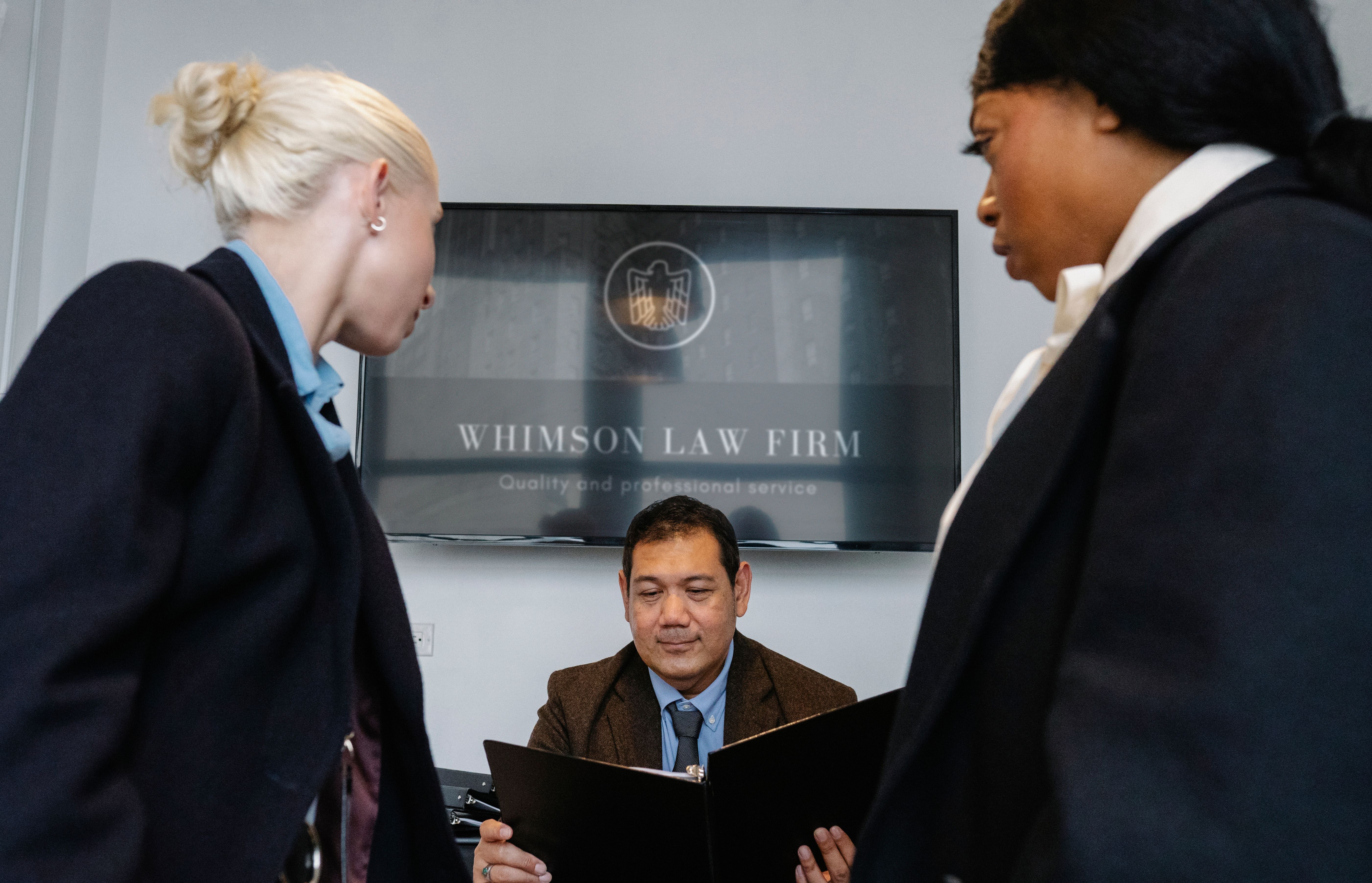 Group of legal professionals collaborating around a contract in a conference room